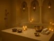 Luxury Moroccan Hammam spa room at Villa 8 Ladies Salon & Spa in Jumeirah 3, Dubai, featuring marble interiors, golden lanterns, candles, and steam creating a serene, private wellness atmosphere.